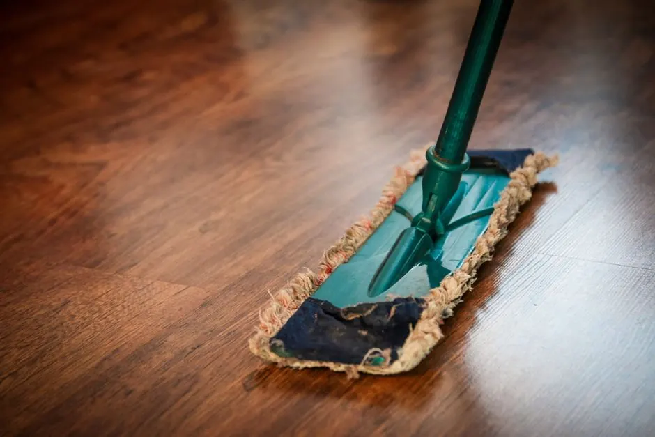 Mopping a wood floor - surface cleaning alone never kills a mold odor in Bedford TX homes